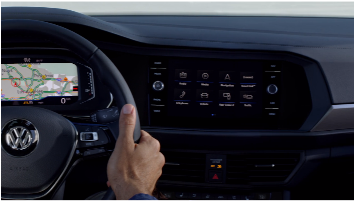 man's hands on the steering wheel of the car