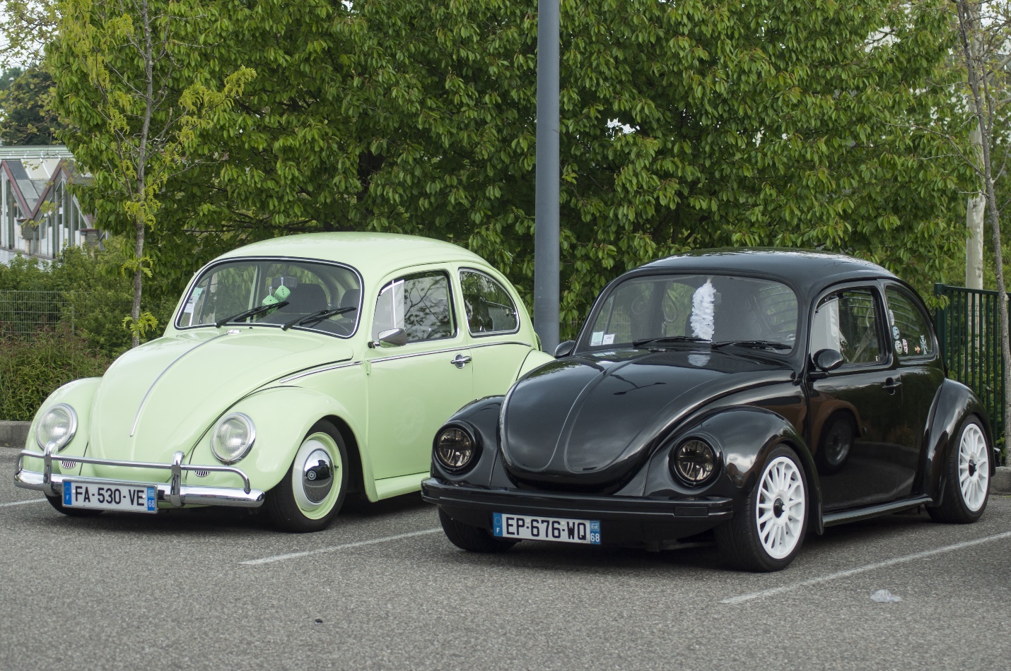 black and green old Volkswagen beetle parked in the street